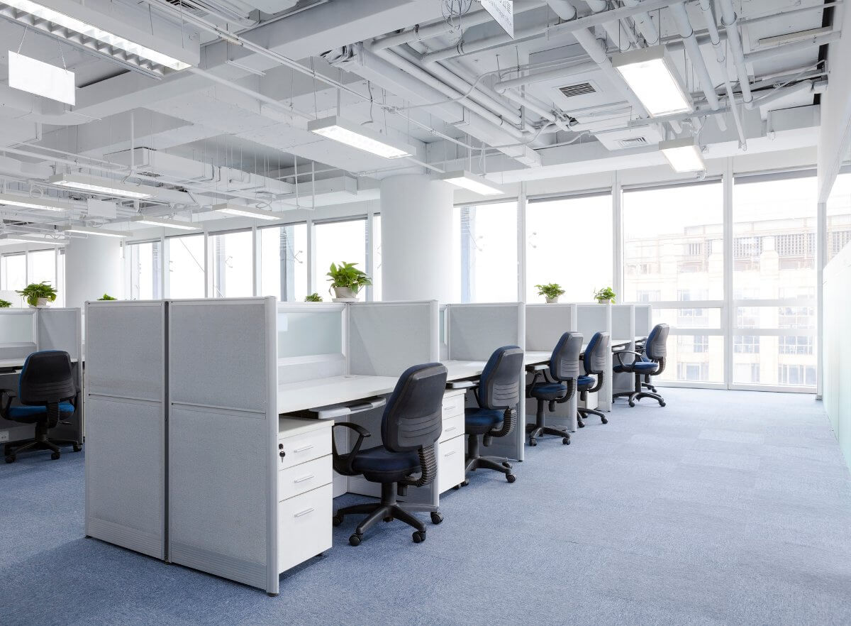 An open-plan office floor with modular cubicle workstations installed