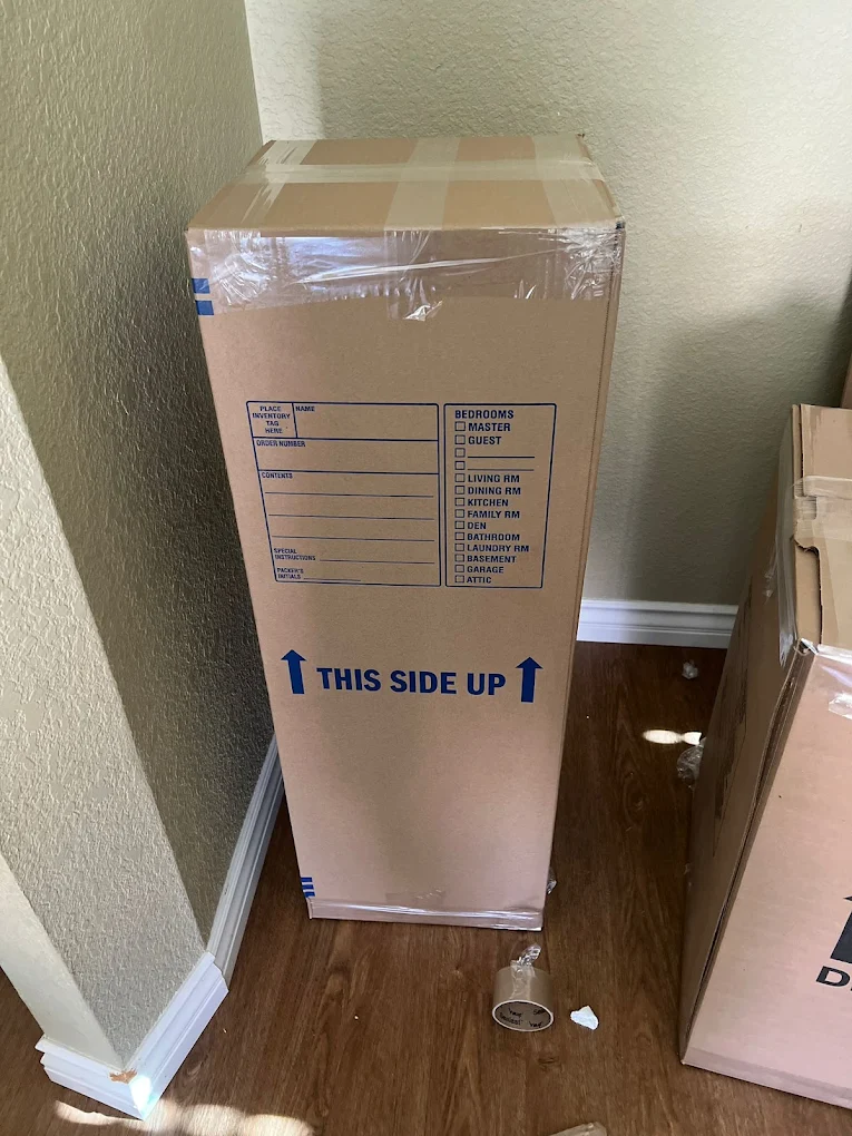 full service movers showing off a box they packed