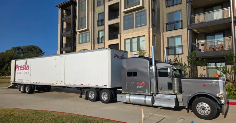 Presto Logistics branded semi-truck parked outside apartment complex